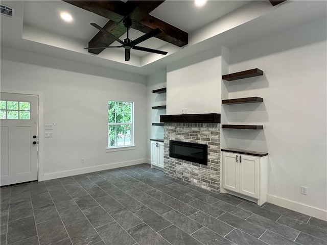 705 Waco St, Bryan, TX 77803 - unfurnished living room with a ceiling fan, coffered ceiling, a glass covered fireplace, recessed lighting, and beam ceiling