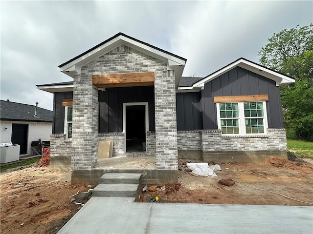view of front of property with board and batten siding and brick siding