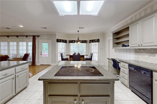 kitchen with a center island, crown molding, and black appliances