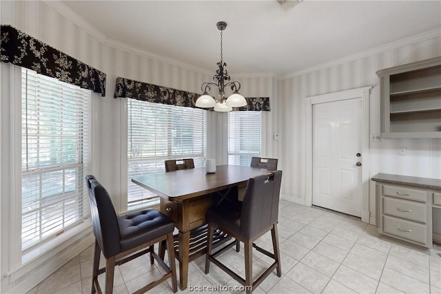 tiled dining room featuring an inviting chandelier and crown molding