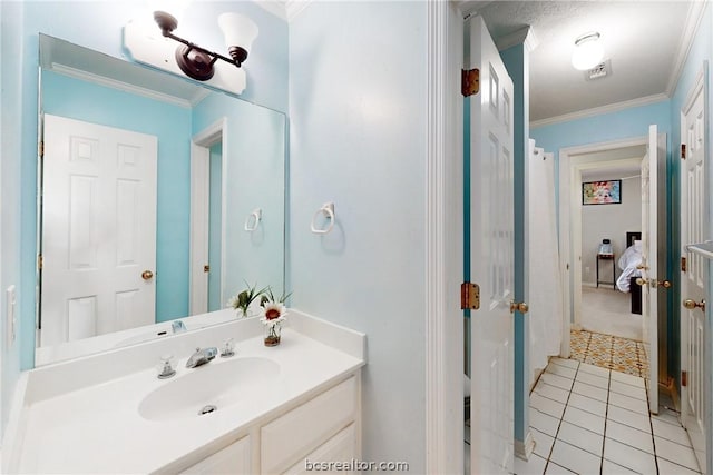 bathroom with tile patterned flooring, vanity, and ornamental molding