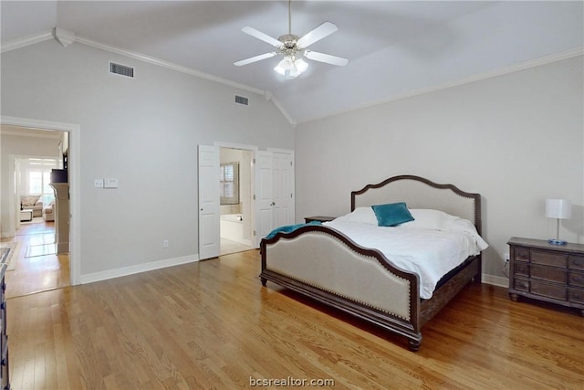 bedroom featuring ceiling fan, high vaulted ceiling, crown molding, ensuite bathroom, and light hardwood / wood-style floors