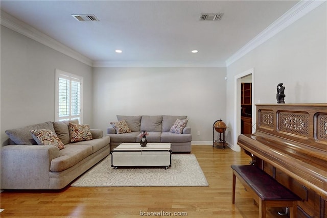 living room featuring light hardwood / wood-style floors and ornamental molding