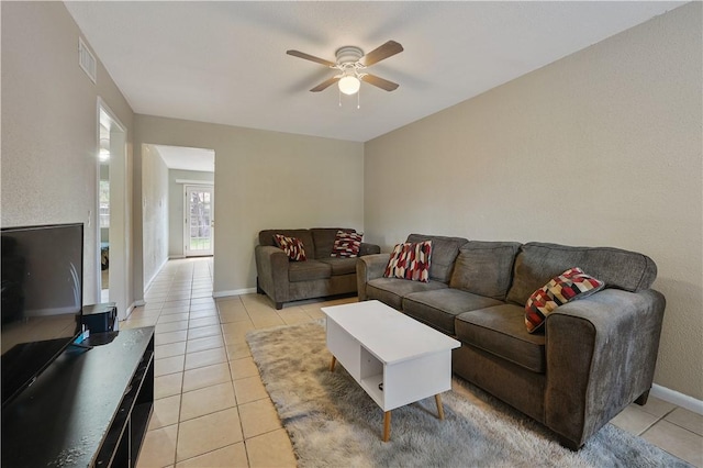 living room featuring light tile patterned floors and ceiling fan