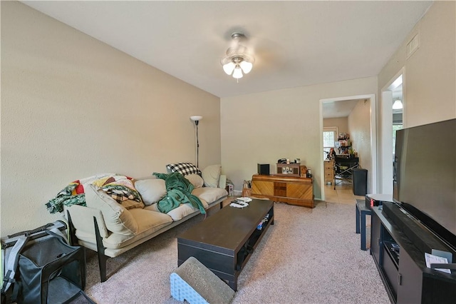 carpeted living room featuring ceiling fan