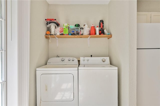 laundry area with washing machine and clothes dryer and laundry area