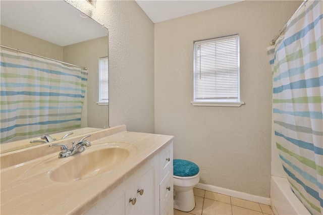 bathroom featuring tile patterned flooring, vanity, and toilet