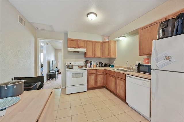 kitchen with sink, light tile patterned flooring, and white appliances