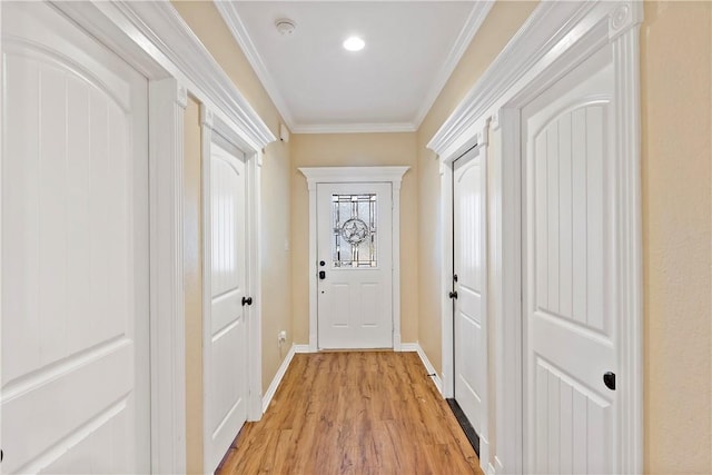 doorway to outside featuring light hardwood / wood-style floors and crown molding