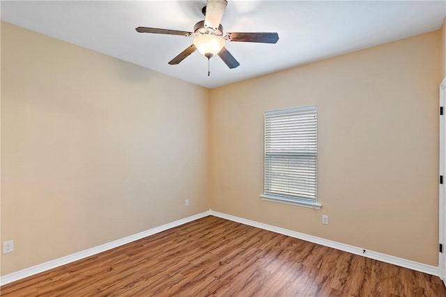 empty room featuring ceiling fan and hardwood / wood-style floors