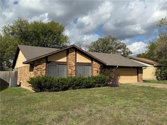 view of front of property featuring central AC unit, a garage, and a front lawn