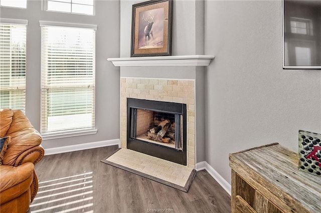 interior details featuring hardwood / wood-style flooring and a brick fireplace