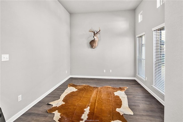 empty room with dark hardwood / wood-style floors