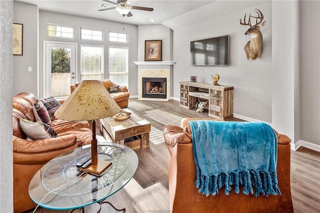 living room featuring wood-type flooring, ceiling fan, and lofted ceiling