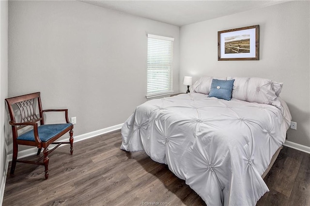 bedroom with dark hardwood / wood-style floors