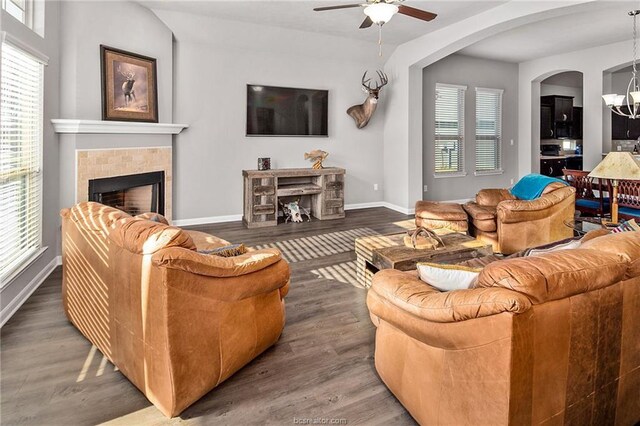 2025 Jester Trl, Bryan, TX 77807 - living area with ceiling fan, wood finished floors, a fireplace, and arched walkways