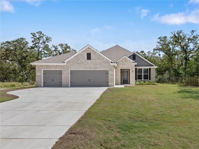 view of front facade with a front yard and a garage