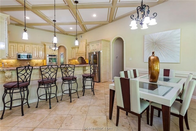 dining area featuring beam ceiling, a high ceiling, coffered ceiling, an inviting chandelier, and light tile patterned floors