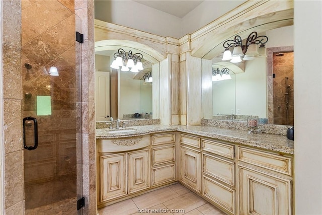 bathroom with tile patterned flooring, vanity, and walk in shower