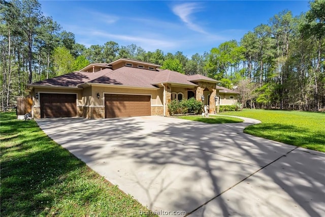 prairie-style house with a garage and a front lawn