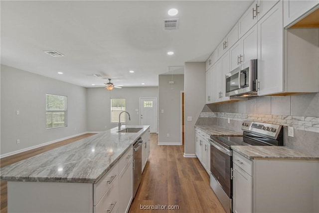 kitchen with white cabinetry, sink, light wood-type flooring, and stainless steel appliances