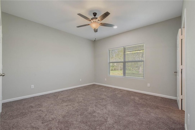 spare room featuring carpet flooring and ceiling fan