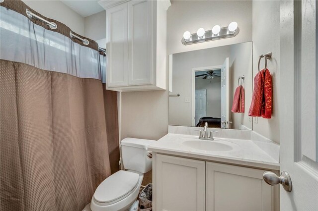 ensuite bathroom featuring toilet, a shower with curtain, ceiling fan, ensuite bath, and vanity