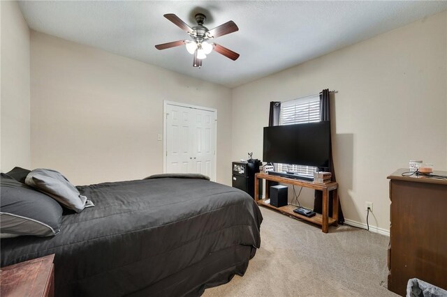 bedroom with light carpet, ceiling fan, and baseboards