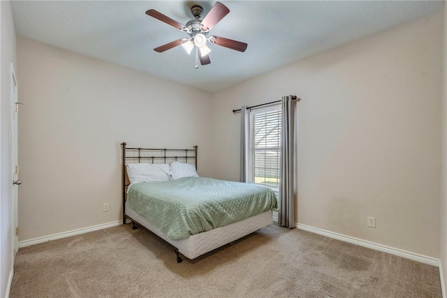 bedroom featuring ceiling fan, carpet, and baseboards
