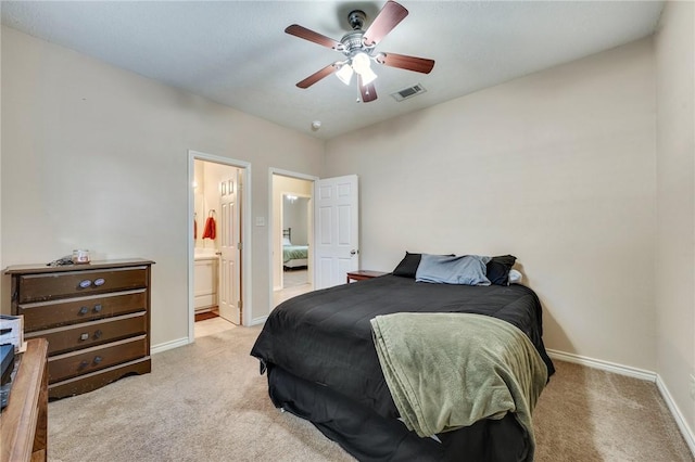 carpeted bedroom featuring ensuite bath, baseboards, visible vents, and ceiling fan