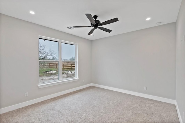 empty room with ceiling fan and carpet floors