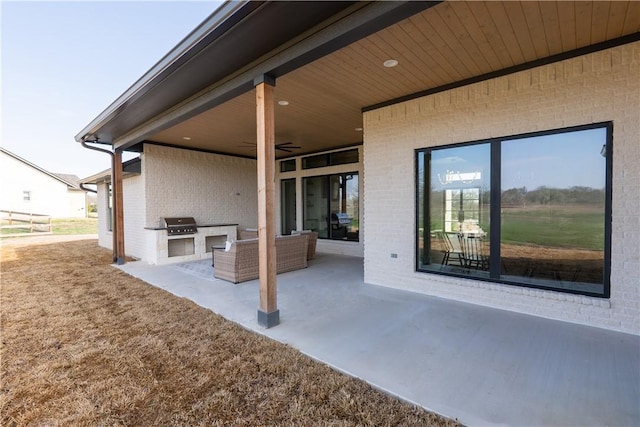 view of patio with exterior kitchen, grilling area, and ceiling fan