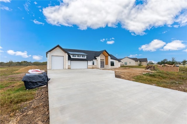 view of front of house with a garage and solar panels