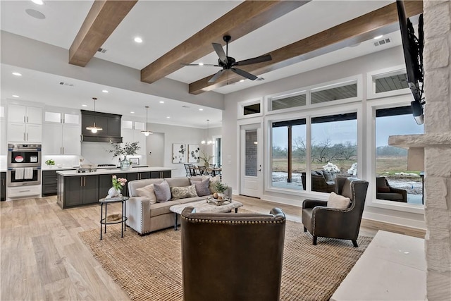 living room with beamed ceiling, ceiling fan, and light hardwood / wood-style flooring