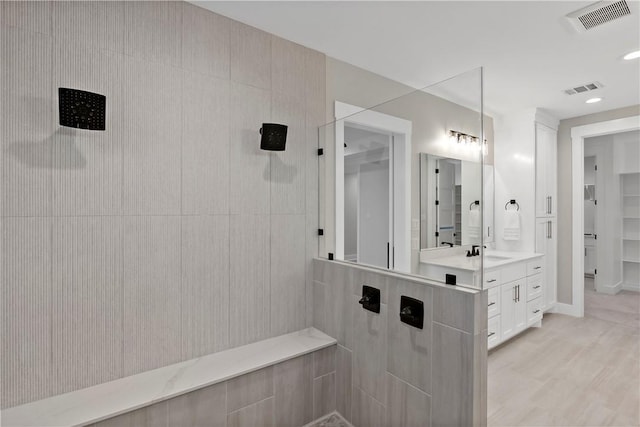 bathroom with vanity and a shower