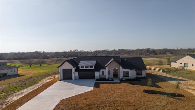 modern farmhouse with a garage and a rural view