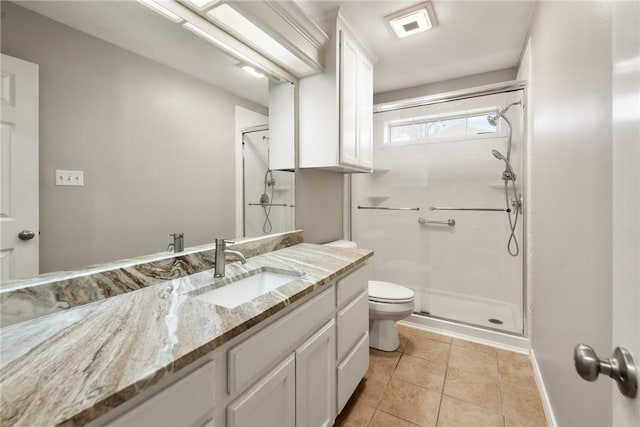 bathroom featuring toilet, vanity, baseboards, a shower stall, and tile patterned floors