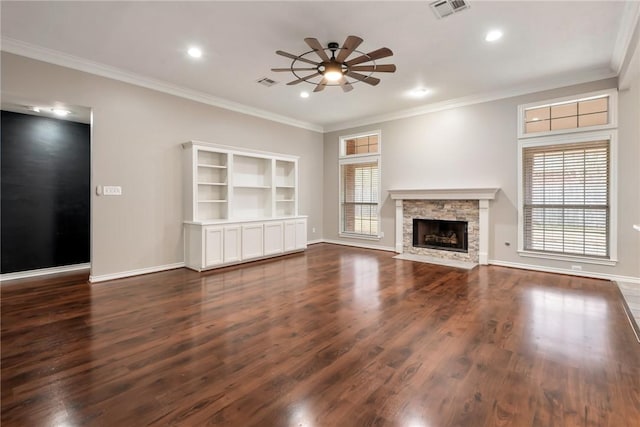 unfurnished living room featuring a wealth of natural light, visible vents, and dark wood finished floors