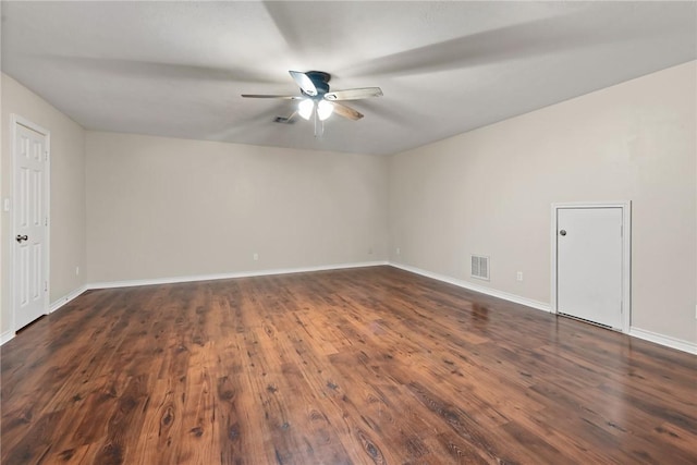 unfurnished room featuring dark wood-style floors, baseboards, visible vents, and a ceiling fan