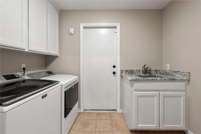 laundry room with cabinet space, washer and clothes dryer, a sink, and light tile patterned flooring