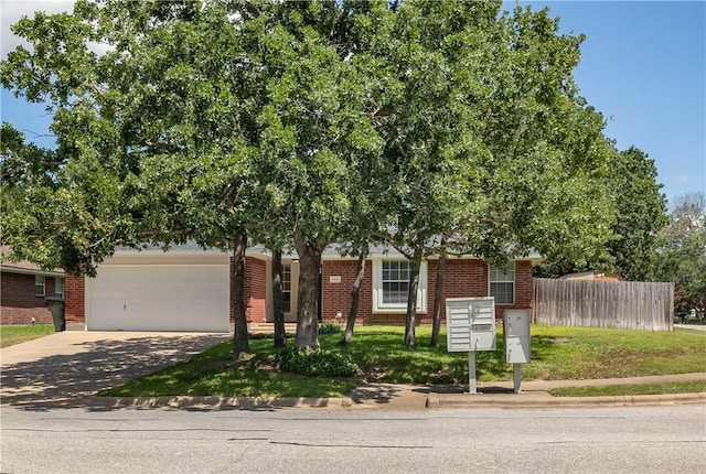 view of property hidden behind natural elements featuring a garage