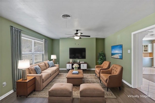 living room featuring hardwood / wood-style floors and ceiling fan