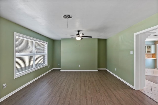 unfurnished room with ceiling fan and dark hardwood / wood-style floors