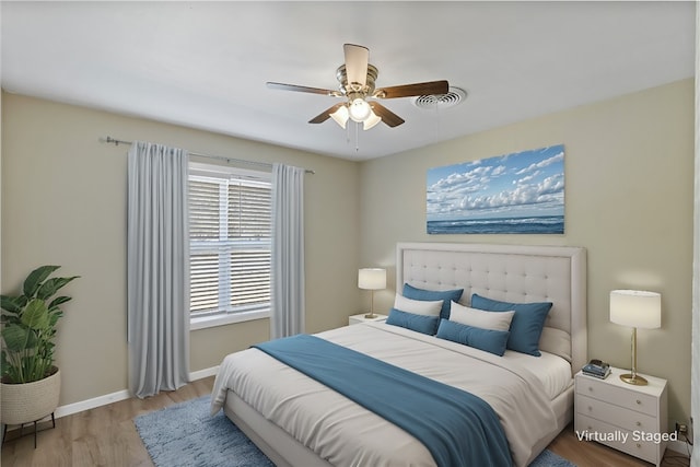 bedroom with ceiling fan and light hardwood / wood-style flooring