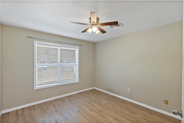 spare room with light wood-type flooring and ceiling fan