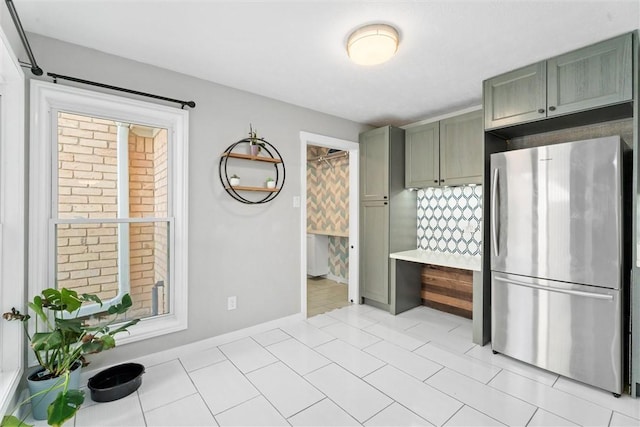 kitchen featuring stainless steel refrigerator and light tile patterned floors