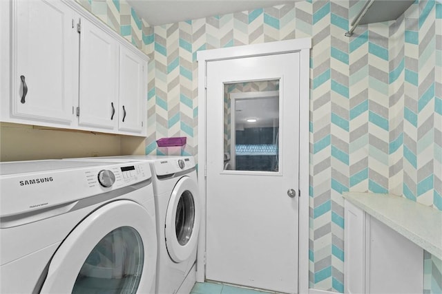 laundry area with cabinets and washing machine and dryer