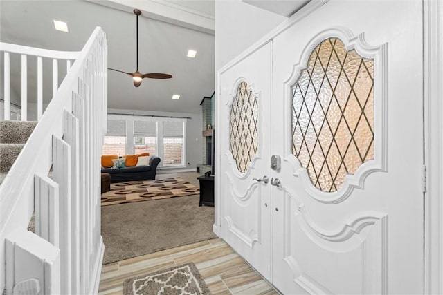 entrance foyer featuring vaulted ceiling and light hardwood / wood-style floors