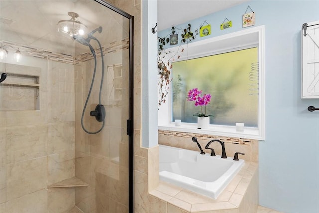 bathroom featuring separate shower and tub