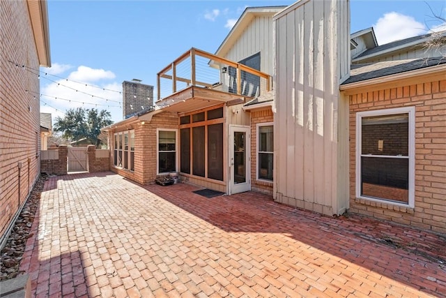 rear view of house featuring a patio area and a balcony